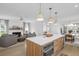 A full kitchen with stainless steel appliances opens into a living room and dining room at 578 Island Walk East, Mount Pleasant, SC 29464