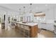 Bright, open kitchen with oversized island featuring a stone countertop and seating for four at 578 Island Walk East, Mount Pleasant, SC 29464