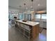 Bright kitchen features a large island with seating, pendant lighting, and stainless steel appliances at 578 Island Walk East, Mount Pleasant, SC 29464