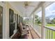 Relax on this covered porch with ceiling fans and comfortable seating, perfect for enjoying neighborhood views at 578 Island Walk East, Mount Pleasant, SC 29464