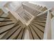 Modern staircase with light wood treads and black metal railings creating a captivating geometric design at 578 Island Walk East, Mount Pleasant, SC 29464