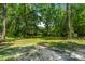 View of the expansive backyard surrounded by lush greenery and mature trees, ensuring privacy and a natural setting at 610 Old Golf Rd, Summerville, SC 29483
