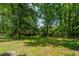 A tranquil backyard view showcases mature trees, offering a serene and private outdoor space at 610 Old Golf Rd, Summerville, SC 29483