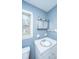 Bathroom with blue walls, window and toilet at 610 Old Golf Rd, Summerville, SC 29483