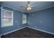Bedroom with hardwood floors, ceiling fan and two windows at 610 Old Golf Rd, Summerville, SC 29483