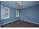 Bedroom with hardwood floors, ceiling fan and two windows at 610 Old Golf Rd, Summerville, SC 29483