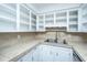 A well-lit kitchen featuring white cabinets and a double basin stainless steel sink at 610 Old Golf Rd, Summerville, SC 29483