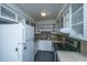Functional kitchen features white cabinets, laminate countertops, and standard appliances at 610 Old Golf Rd, Summerville, SC 29483