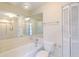 Bright bathroom featuring a white bathtub with tile surround, mirrored wall, and toilet at 638 Harbor Creek Pl # 19, Charleston, SC 29412