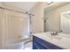 Cozy bathroom featuring a shower over tub with white tile surround and vanity with a framed mirror at 638 Harbor Creek Pl # 19, Charleston, SC 29412