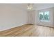 Bright bedroom with wood floors, ceiling fan, and a large window overlooking the trees at 638 Harbor Creek Pl # 19, Charleston, SC 29412