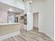 Open-concept kitchen with black appliances, tile backsplash, and wood flooring at 638 Harbor Creek Pl # 19, Charleston, SC 29412