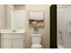 Bright bathroom with a white vanity, modern fixtures, and framed art at 639 Culpepper St, Summerville, SC 29486