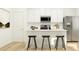 Well-lit kitchen featuring a modern island with seating, stainless steel appliances and sleek countertops at 639 Culpepper St, Summerville, SC 29486