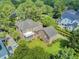 Aerial view of brick home showcasing large lot, deck, screened porch, mature trees at 750 Navigators Run, Mount Pleasant, SC 29464