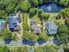 Drone shot highlighting neighborhood, mature trees, lush backyard, swimming pool and serene water feature at 750 Navigators Run, Mount Pleasant, SC 29464