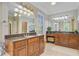 Luxurious bathroom featuring dual vanities, granite countertops, custom cabinetry, and plenty of natural light at 750 Navigators Run, Mount Pleasant, SC 29464