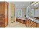 Well-appointed bathroom featuring a glass-enclosed shower, soaking tub, custom cabinets, and a vanity area at 750 Navigators Run, Mount Pleasant, SC 29464