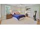 Inviting bedroom with neutral carpet, desk, built-in shelving, large window, and bed with colorful pillows at 750 Navigators Run, Mount Pleasant, SC 29464
