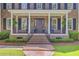 Inviting front porch with brick stairs, columns, and a dark wood front door at 750 Navigators Run, Mount Pleasant, SC 29464
