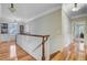 Upstairs hallway with hardwood floors, built-in bookshelves, and natural light, creating an inviting transition between rooms at 750 Navigators Run, Mount Pleasant, SC 29464