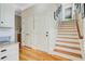 Hallway features wood floors, a wooden staircase, white wainscoting, and access to multiple rooms at 750 Navigators Run, Mount Pleasant, SC 29464