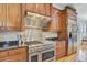 Modern kitchen featuring a stainless steel stove, granite counters, and custom cabinetry at 750 Navigators Run, Mount Pleasant, SC 29464
