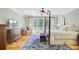 Beautifully lit main bedroom with a four-poster bed, balcony access, and hardwood flooring at 750 Navigators Run, Mount Pleasant, SC 29464