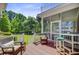 Outdoor living space offering comfortable wicker seating with a view to a large, green backyard at 750 Navigators Run, Mount Pleasant, SC 29464