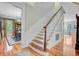 Elegant staircase with hardwood treads and white risers, leading to the second floor with views to the dining room at 750 Navigators Run, Mount Pleasant, SC 29464