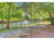 Scenic view of a tranquil pond with a fountain, surrounded by lush trees and greenery at 750 Navigators Run, Mount Pleasant, SC 29464