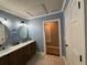 Bathroom with double sink vanity, tile floor, and doorway to another room at 762 Swanson Ave Ave, Charleston, SC 29412