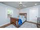 Cozy bedroom with a wooden bed frame, ceiling fan, and light blue accents at 762 Swanson Ave Ave, Charleston, SC 29412