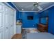 Blue bedroom featuring a bed, dresser, aquarium, ceiling fan, and closet at 762 Swanson Ave Ave, Charleston, SC 29412