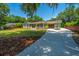 Well-maintained home with a long driveway, basketball hoop, and lush green lawn at 762 Swanson Ave Ave, Charleston, SC 29412
