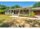 Beautiful single-story home featuring a welcoming porch with rocking chairs and manicured landscaping at 762 Swanson Ave Ave, Charleston, SC 29412