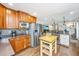 Open kitchen with stainless steel appliances, wood cabinetry, island, and view to living area at 762 Swanson Ave Ave, Charleston, SC 29412
