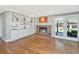 Cozy living area with fireplace, built-in shelving, and access to outdoor patio with lots of light at 762 Swanson Ave Ave, Charleston, SC 29412