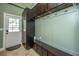 Mudroom with dark wood cabinets, storage bench, coat hooks, and door to the exterior at 762 Swanson Ave Ave, Charleston, SC 29412