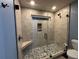 Walk-in shower featuring pebble floor, tiled walls, and glass door at 762 Swanson Ave Ave, Charleston, SC 29412