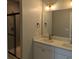 Modern bathroom featuring double sinks, white cabinets, and a glass shower at 7763 Park Gate Dr, North Charleston, SC 29418