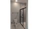 Well-lit bathroom featuring a toilet and glass-enclosed shower with gray subway tiles at 7763 Park Gate Dr, North Charleston, SC 29418