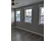 Bright bedroom with three large windows, hardwood floors, and neutral wall color at 7763 Park Gate Dr, North Charleston, SC 29418