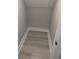 View of a small walk-in closet with hardwood floors at 7763 Park Gate Dr, North Charleston, SC 29418