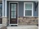 Charming entryway featuring a brown front door, stone accents, and a small window at 7763 Park Gate Dr, North Charleston, SC 29418