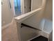 Hallway and stairs with neutral carpet and black metal banister and white trim at 7763 Park Gate Dr, North Charleston, SC 29418
