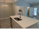 Bright kitchen island with stainless steel sink, dishwasher, and modern gold-toned faucet at 7763 Park Gate Dr, North Charleston, SC 29418