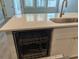 Gleaming white kitchen island with stainless steel dishwasher beneath granite countertop at 7763 Park Gate Dr, North Charleston, SC 29418