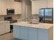 Stylish kitchen with white cabinets, quartz countertops, stainless steel appliances, and center island at 7763 Park Gate Dr, North Charleston, SC 29418