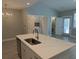 Bright kitchen island with stainless steel sink, dishwasher, and modern gold-toned faucet at 7763 Park Gate Dr, North Charleston, SC 29418